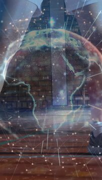 Vertical video: Ball popping causing player picking ball for sports, holo globe over Africa nodes