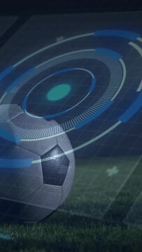 Soccer ball sitting on pitch, sports HUD appearing, rotating rings covering ball, revealing UI