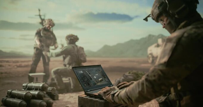 Special Operations Soldiers at Digital Base in a Middle East Desert War, Using Laptop to Monitor Targets, Precision Strike Planning Beside Munitions, Helicopter Overwatch, Armored Transport