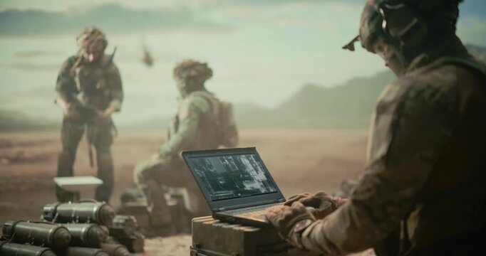 Special Forces Soldiers Run a Desert Surveillance Base, Analyzing ISR Imagery on Laptop, Relaying Reconnaissance Data, Coordinating Target Tracking With Field Team During  War Combat Operation