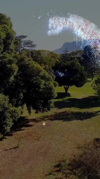 Vertical video: Camera rising, AR dot orb moving and rotating, revealing sunlit lawn and mountains