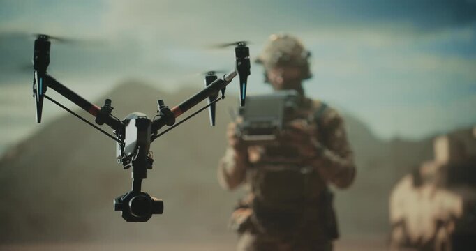Special Forces Drone Operator Hovers a Tactical Quadcopter Drone at a Desert Base, Battlefield Mapping, Precision Strike, Target Tracking, Reconnaissance With a Control Station Modern Military War