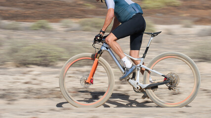 Fototapeta premium Mountain biker in action on a stone trail concept for healthy lifestyle, exercise and extreme sports.Bike panning shot