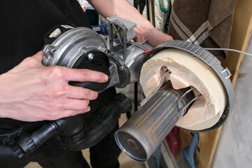 Fototapeta premium Technician hands checking boiler electrodes during annual maintenance inside the heating unit.