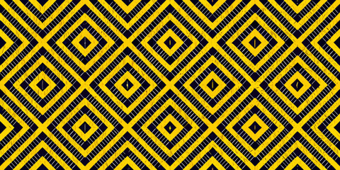 Bold yellow and black diamond pattern creates a striking geometric background © Rakesh