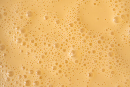 Orange milkshake texture closeup