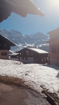 Town of M&uuml;rren with Traditional Swiss Chalets and Snow-Capped Alps