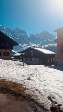 Sunny Winter Day in M&uuml;rren with Traditional Swiss Chalets and Snow-Capped Alps