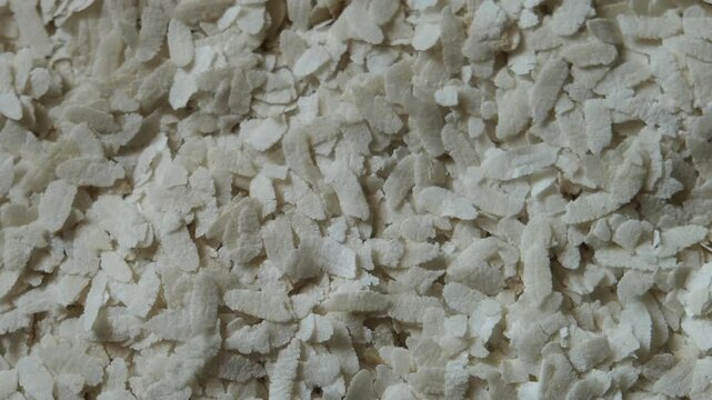 Top view of dry flattened rice flakes (Poha)