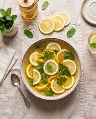Fresh Lemon Jelly Dessert with Mint Leaves and Citrus Pieces on Light Table Background, Flat Lay Summer Sweet Food Concept
