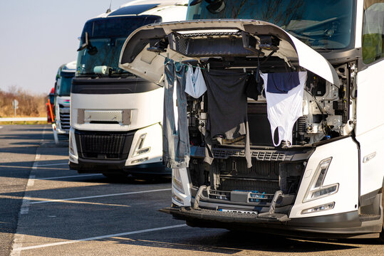 Drying clothes under the hood of a truck.