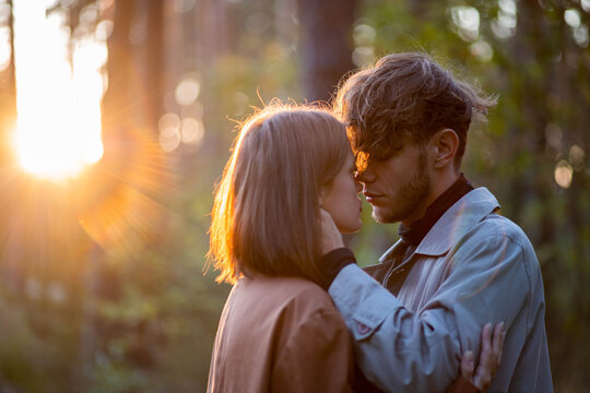 A loving couple hugging in the forest, a relationship crisis and separation