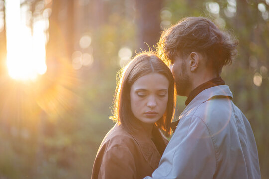 A loving couple hugging in the forest, a relationship crisis and separation