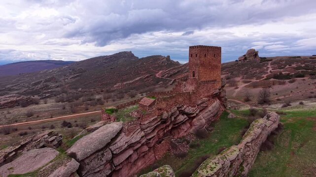 Aerial view of the medieval Castle of Zafra built on a dramatic sandstone ridge in Spain, a historic fortress known as a filming location featured in the Game of Thrones series
