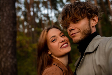 Fototapeta premium A selfie of a young beautiful couple on a walk in the forest