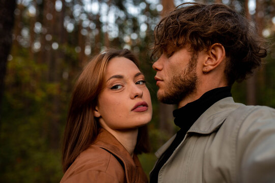 A selfie of a young beautiful couple on a walk in the forest