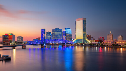 Jacksonville, Florida, USA. Cityscape image of Jacksonville, Florida with reflection of the city skyline in the water at beautiful sunset.