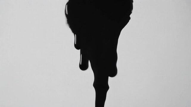 black liquid splatter silhouette on gray background