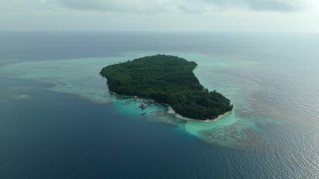Aerial view of Menjangan Besar Island showing the contrast between the lush green vegetation and the turquoise waters, Karimunjawa, Jawa Tengah, Indonesia.