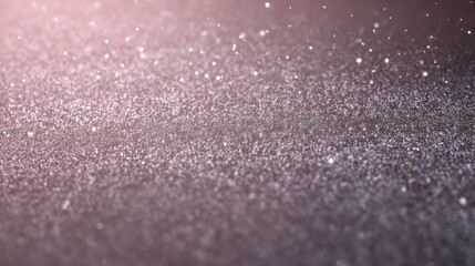 Obraz premium A shimmering close-up view of delicate pink and purple glitter particles creating a magical bokeh effect.