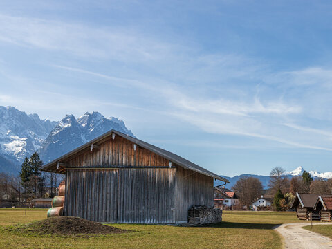 Rural barn and path with Alpine mountains in Bavaria Germany
