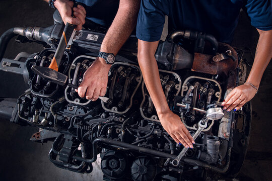 Mechanic Hands Repairing Engine Components in Workshop