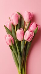 Fototapeta premium Springtime elegance: a pastel display of nature's beauty. High-end fashion. A touch of spring: lightly scattered pink tulips. Lavish clothing. Designer fashion.