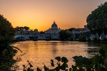 Naklejka premium Rome river bridge and St Peter's Basilica at sunset