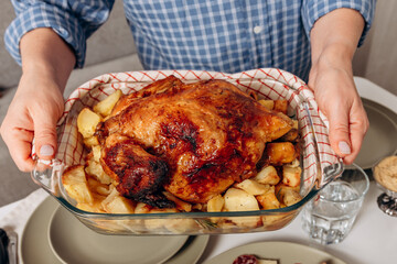 Roast Chicken or a turkey  With Potatoes Served At A Cozy Family Dinner Table With Red Wine