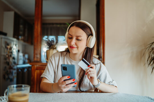 Woman shopping online using smartphone and credit card