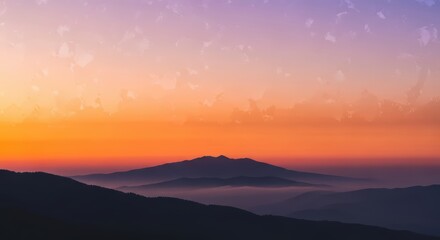 Obraz premium Majestic Mountain Range at Sunrise with Hazy Valleys and Colorful Sky