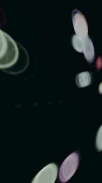 Circular objects changing position on a dark background