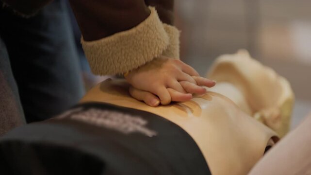 Person performing cpr chest compressions on medical mannequin