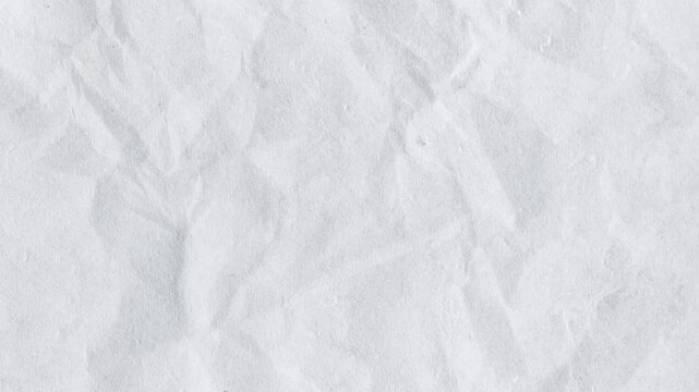 A blank sheet of white cotton fabric with a crumpled paper texture features a rough, wrinkled surface and vintage grunge pattern reminiscent of crushed winter snow or old marble material