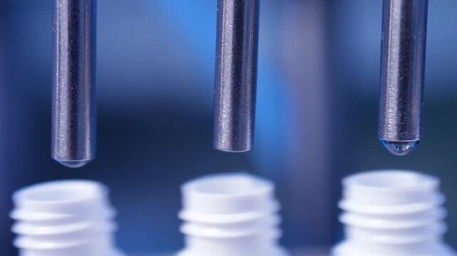 eye drop manufacturing. Ophthalmic drops solution, eye ear drop making process in factory. eye drop medicine in plastic bottles on conveyor belt. production of medical drops in a pharmaceutical line