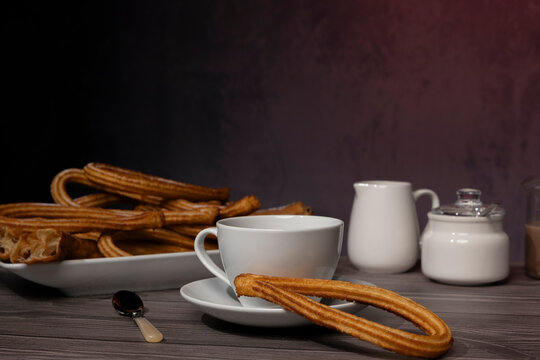 Sweet fried dough churros served with chocolate drink