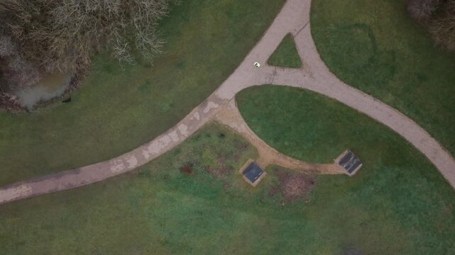Runner running through the park, past a bench