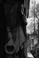 Naklejka premium Old European Graveyard with tombstones, crosses and religious symbols, spooky atmosphere, black and white, Pere la Chaise Cemetery, Paris France