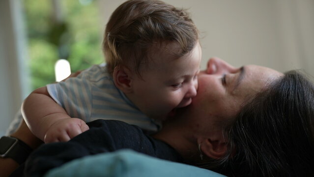 Baby playfully pressing face against mother&rsquo;s cheek, affectionate moment, bonding, baby curiosity, mother smiling, warm connection, parent-child interaction