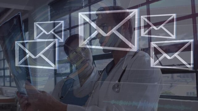 Animation of envelope icons over caucasian doctors talking