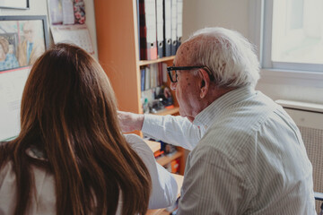Elderly man receiving support from daughter at home