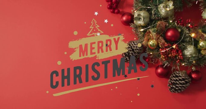 Merry Christmas text animation over festive decorations with pinecones and ornaments