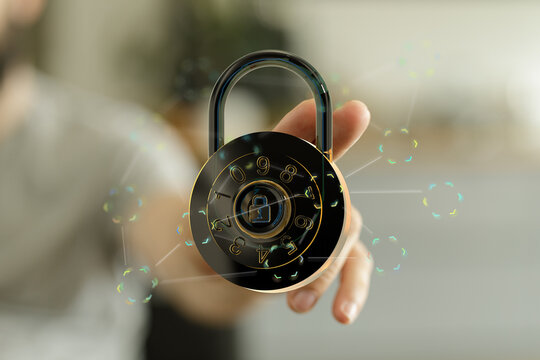 Close-up of a hand holding a digital padlock representing data protection, cyber security, and network safety. Safe, sec