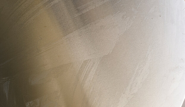 Textured background showing a close-up of a brushed metal surface with subtle imperfections, ideal for design elements.
