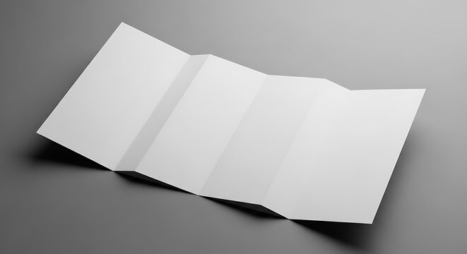 Blank white tri-fold brochure lays open on a plain gray surface.