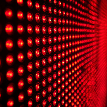 Red light therapy texture close up glowing LED lights in repeating pattern creating vibrant and energetic visual effect