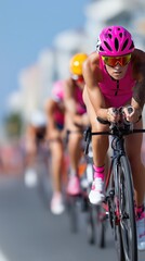 Blurred in motion: Female cyclists racing in pink gear in a close formation on a sunny day