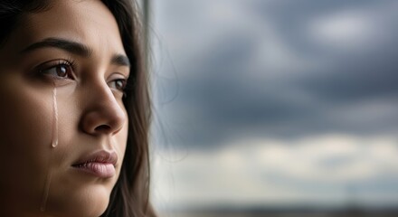 Young woman in tears, expression of deep sadness, emotional pain, and melancholy