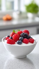 Fresh berry topped yogurt in white bowl on kitchen counter