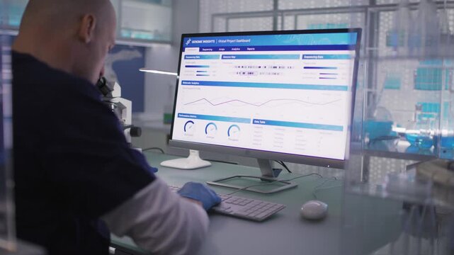 Male scientist or a doctor in protective glove working in a medical laboratory. Typing on a computer and examining the data